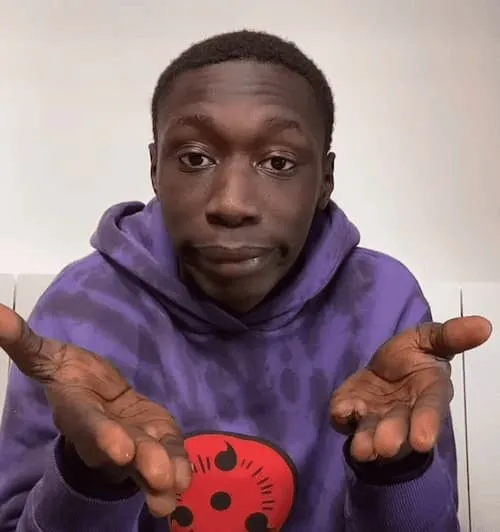 Khaby Lame doing his signature 'hands out' pose